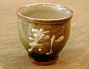 ash glazed tea cup with the word "Kotobuki" written in kanji